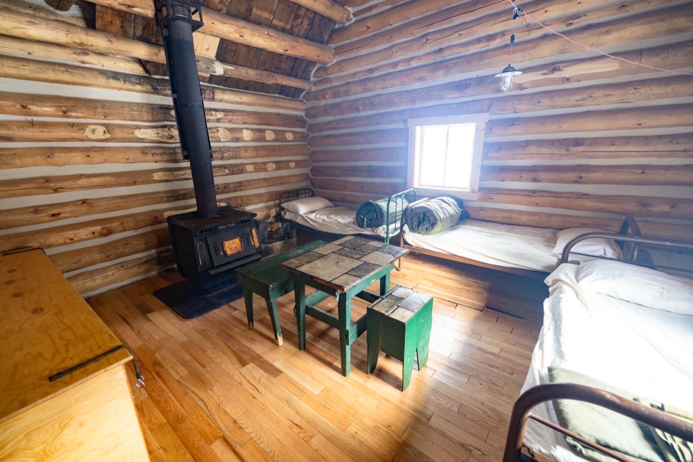 Cabin room with warm bedding and a view of the valley